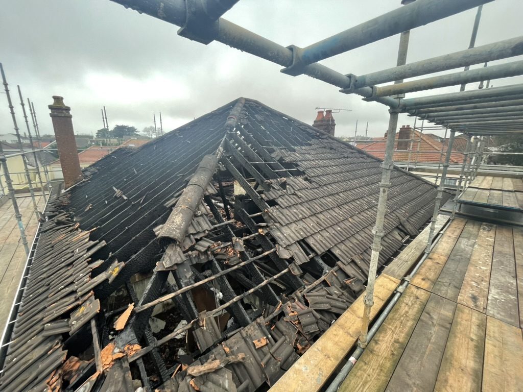 Fire-damaged roof with scaffolding — St Brelade