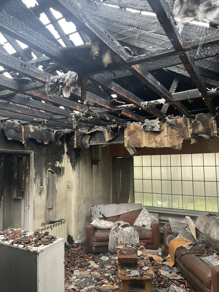 Fire-damaged interior — ceiling and room destruction
